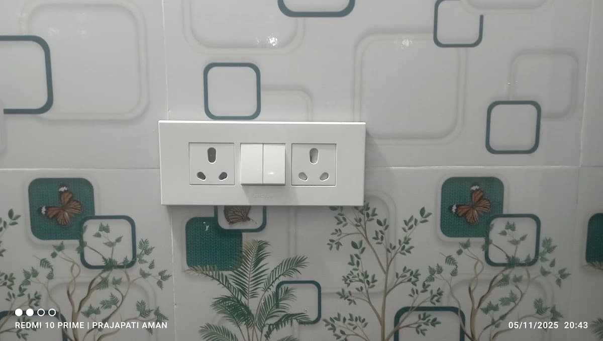 Clean modular switch and socket board installed on designer wallpaper wall in Lucknow by Prajapati Electrical