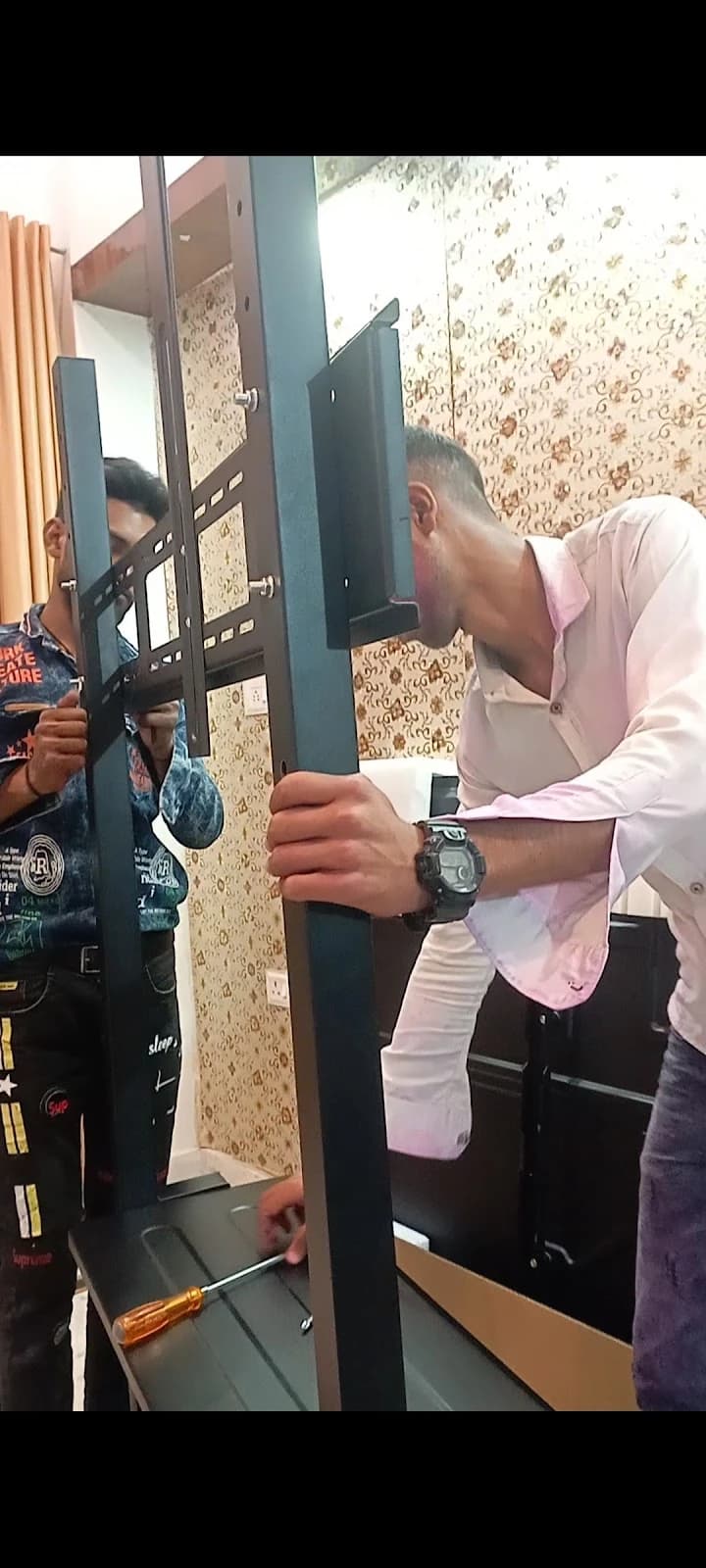 TV wall mount bracket assembly and installation at customer's home in Lucknow by Prajapati Electrical