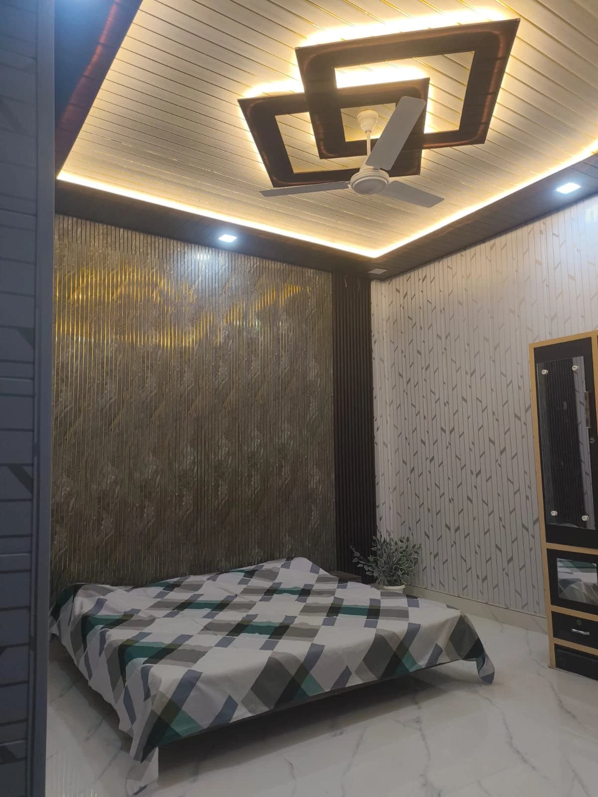 Premium bedroom with designer false ceiling, LED strip lighting, ceiling fan and modern interiors in Lucknow by Prajapati Electrical