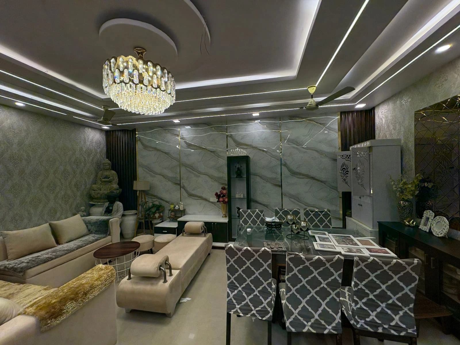 Crystal chandelier and LED cove lighting installed in modern drawing room in Lucknow by Prajapati Electrical