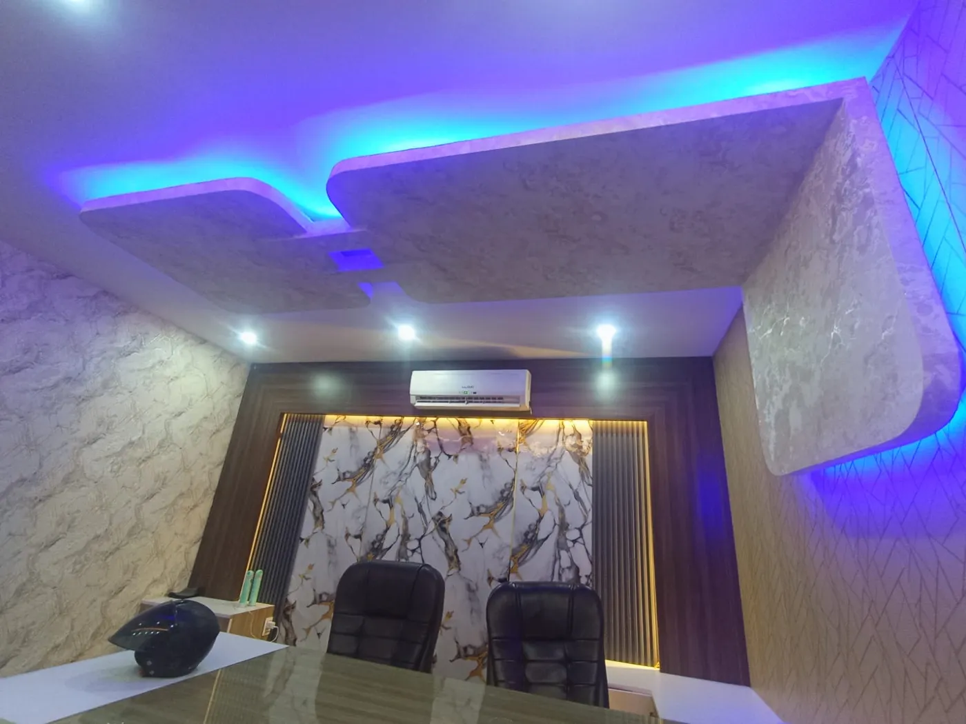 Office cabin with designer false ceiling, blue cove LED, split AC and marble wall panels in Lucknow by Prajapati Electrical