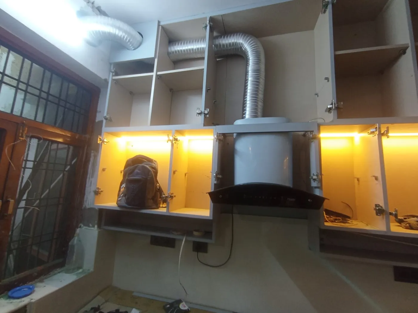 Modular kitchen with chimney, ducting and warm LED cabinet lighting installed in Lucknow by Prajapati Electrical