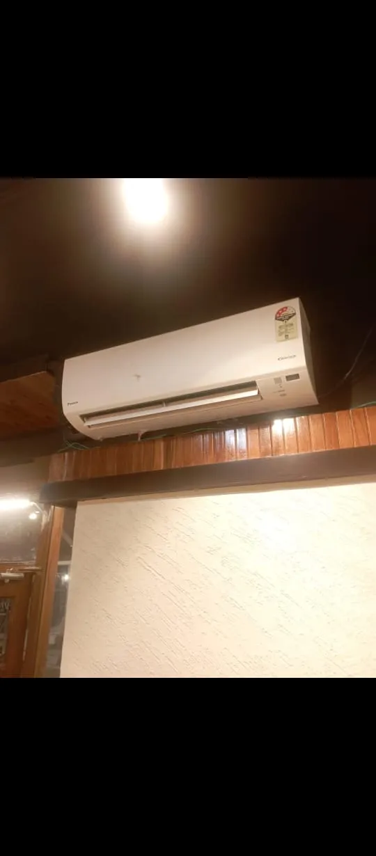 Split AC indoor unit cleanly installed on a wall with wooden trim at customer site in Lucknow by Prajapati Electrical